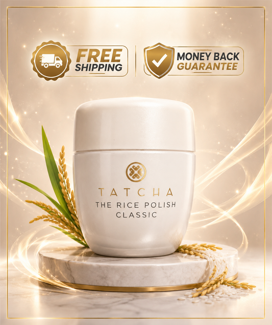 A white cylindrical jar of Tatcha The Rice Polish Classic sits on a marble pedestal with gold accents, surrounded by wheat stalks. The background is a warm beige with glowing light streaks and two promotional badges at the top reading 'FREE SHIPPING' and 'MONEY BACK GUARANTEE'.